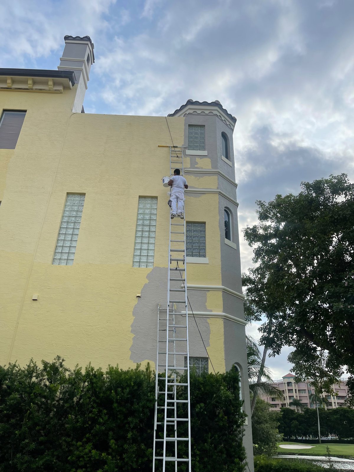 Exterior repaint in progress, yellow to grey