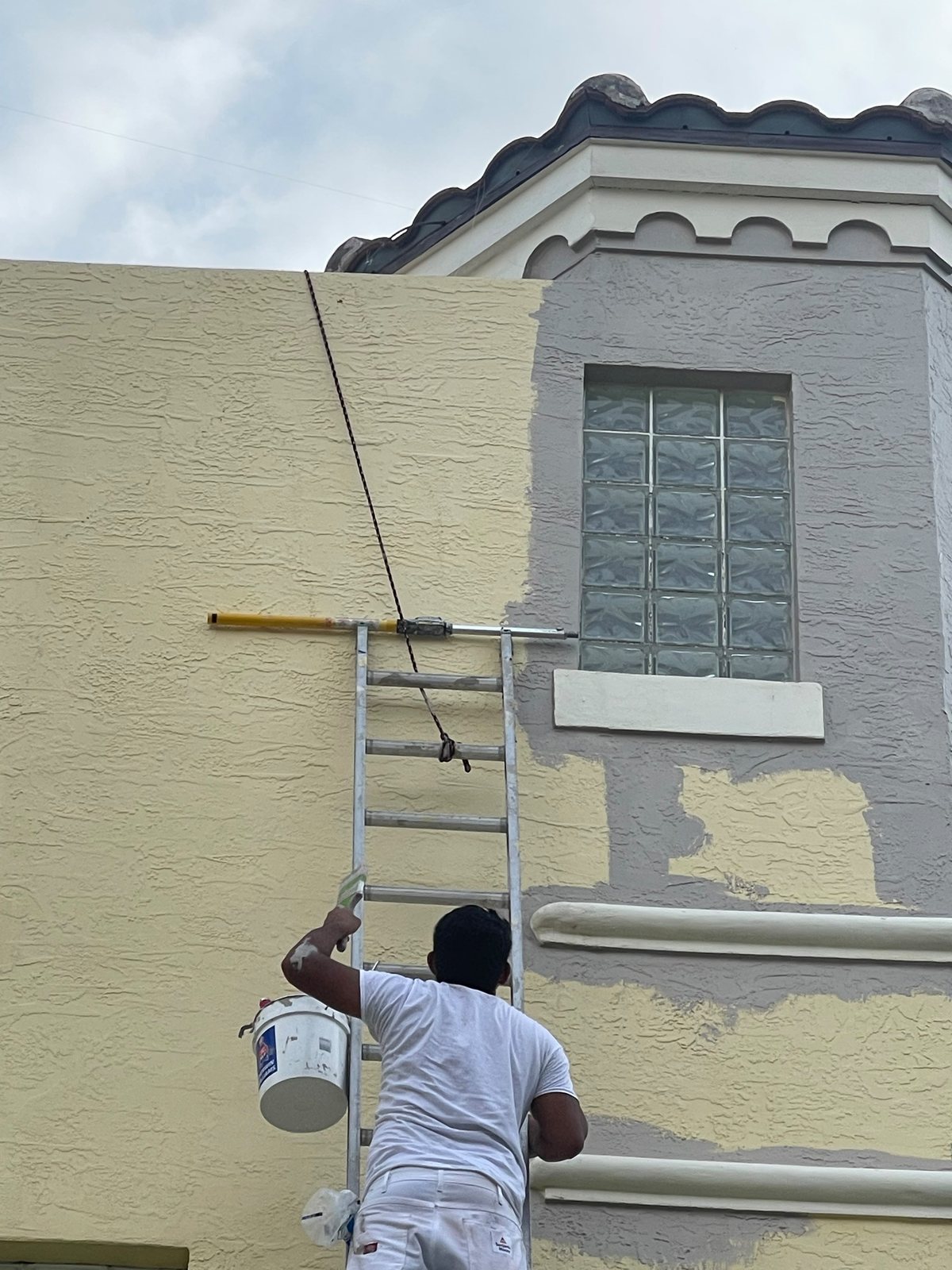 ICS painter cutting in above a window