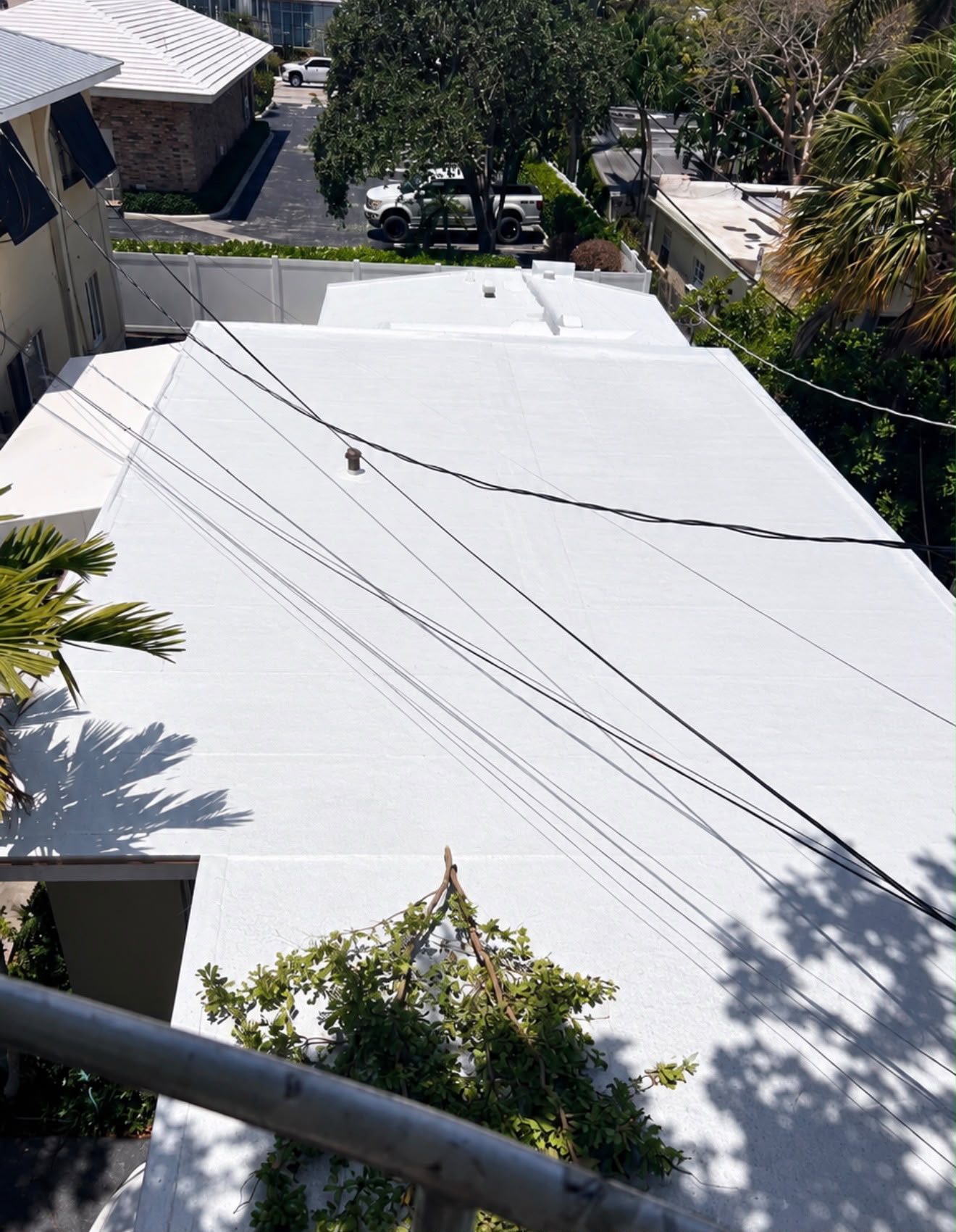 After — A weathered and patched roof, recoated edge to edge.